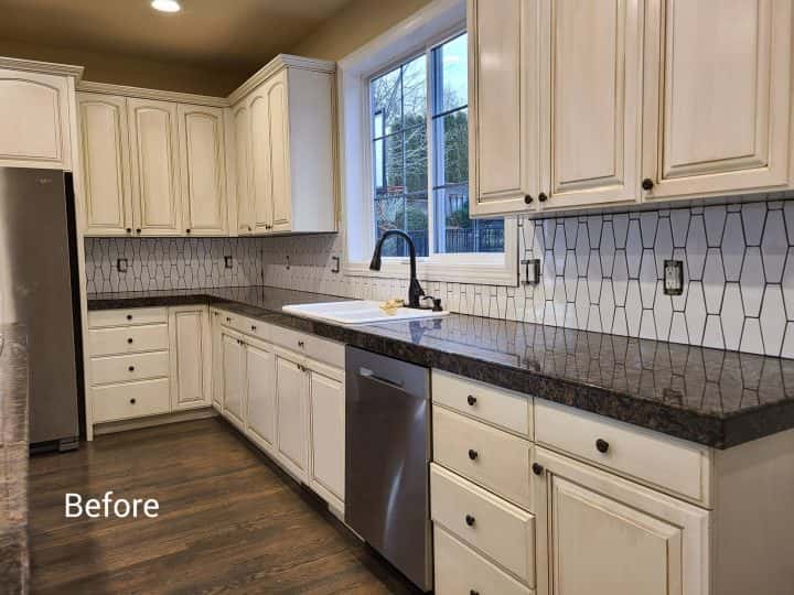 A modern kitchen with white cabinets and stainless steel appliances in Tigard.