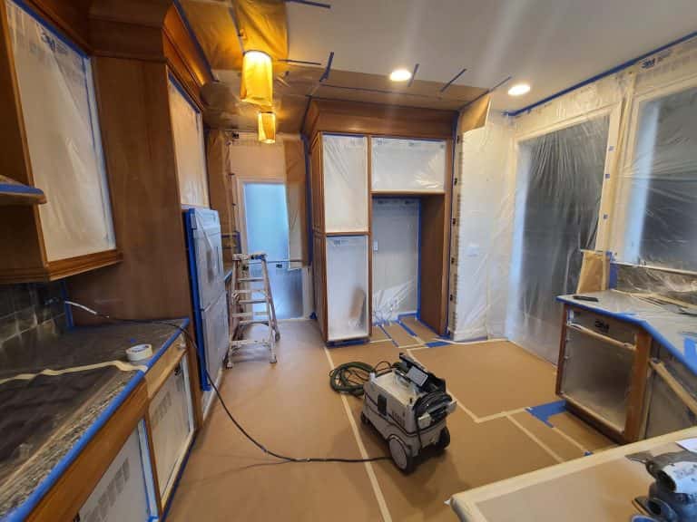 The cabinets in a kitchen located in SW Portland are being repainted with blue paint.