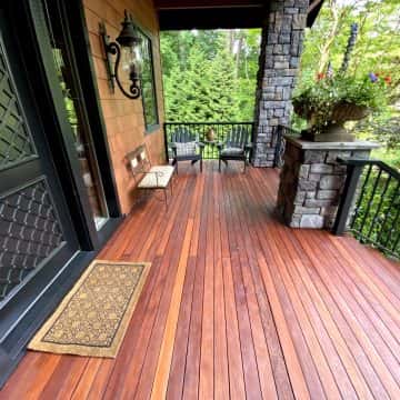 In NW Portland, there is a wooden deck that has undergone restoration, complete with a sturdy railing and a charming door.