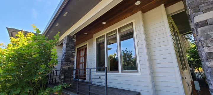 The modern front of a home with a wooden door.