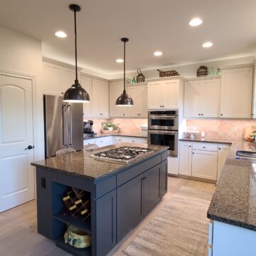 Modern kitchen in Portland with fresh painting by Pearl Painters; light cabinets, gray island, stainless appliances, granite counters.