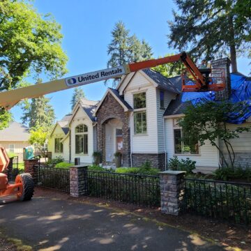Exterior painter working on painting a chimney on a Portland home