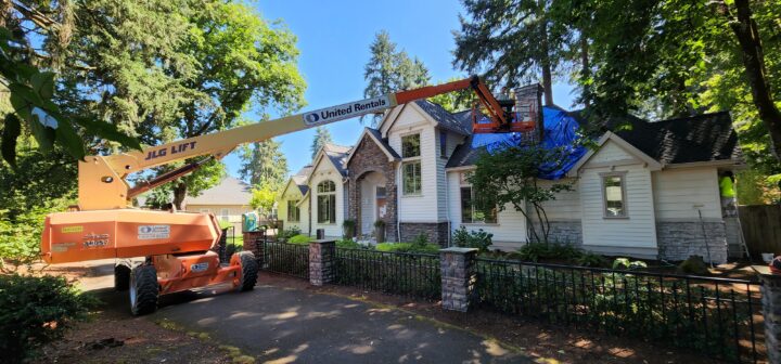 Exterior painter working on painting a chimney on a Portland home