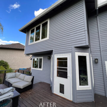 A Beaverton home in the Cooper Mountain Neighborhood with a gray deck featuring a couch and chairs.