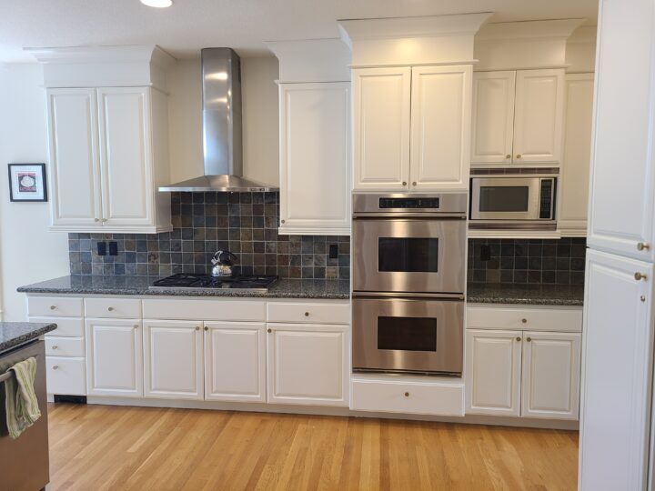 A Portland kitchen with white cabinets and stainless steel appliances.