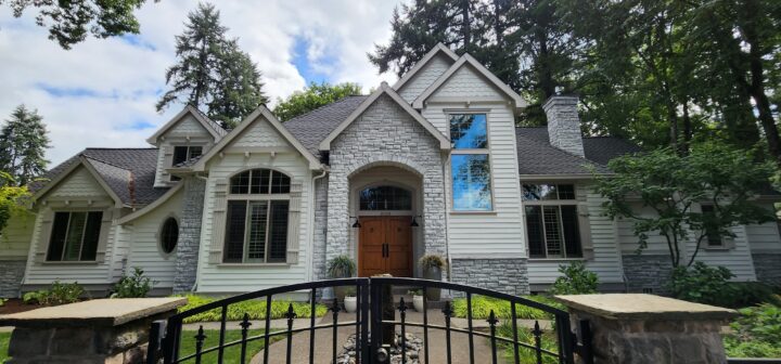 Lake Oswego house painted white with a gate in front of it.