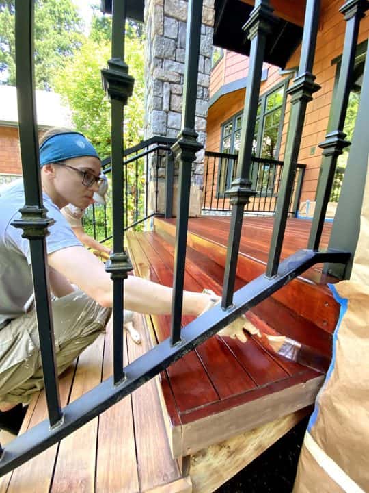 A woman painting a wood stair case in NW Portland.