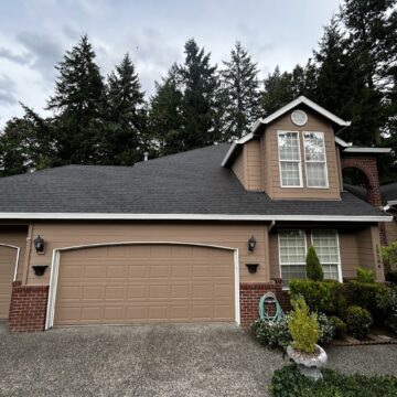 Charming two-story Haase house in Portland with brown exterior, brick accents, two-car garage, and front garden. Pearl Painters will complete painting by June 2025.