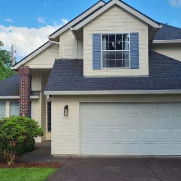 A Tigard home with a garage in front of it.