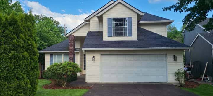 A Tigard home with a garage in front of it.