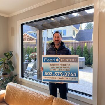 A man standing in front of a living room with a sign advertising Google Review.