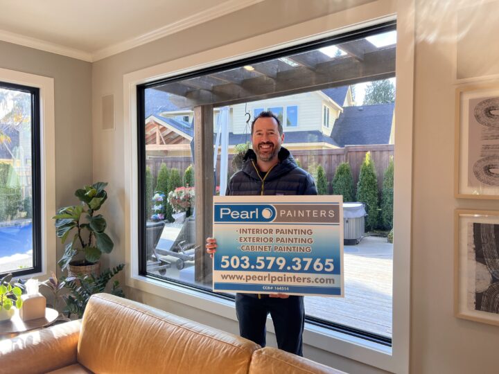 A man standing in front of a living room with a sign advertising Google Review.