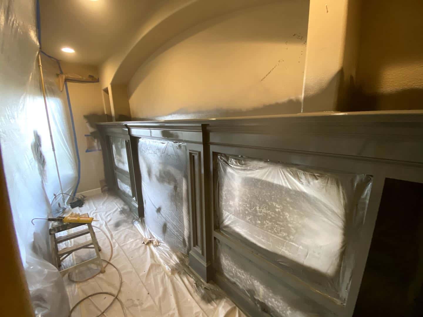 Photo of Sherwood family room gets fresh painted fireplace surround with built-in cabinets to warm it up. in Portland, Oregon