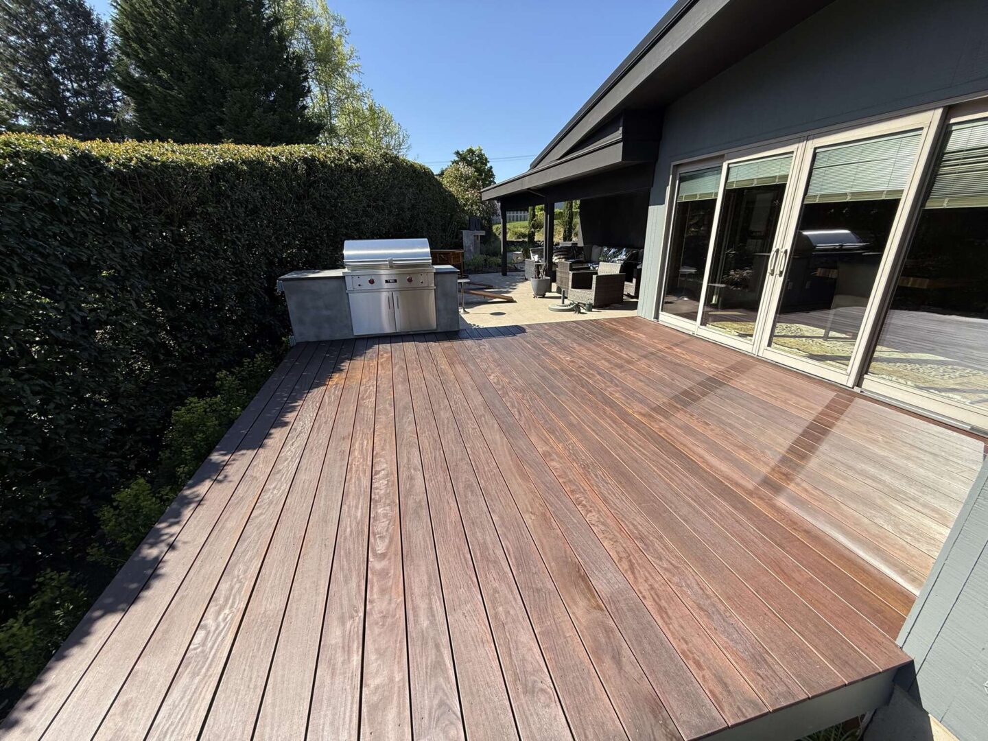 This Godbey home in Portland features a spacious deck with a grill and barbecue. Pearl Painters, a local painting company, recommends scheduling your exterior painting or deck staining before outdoor gatherings begin in April 2025.