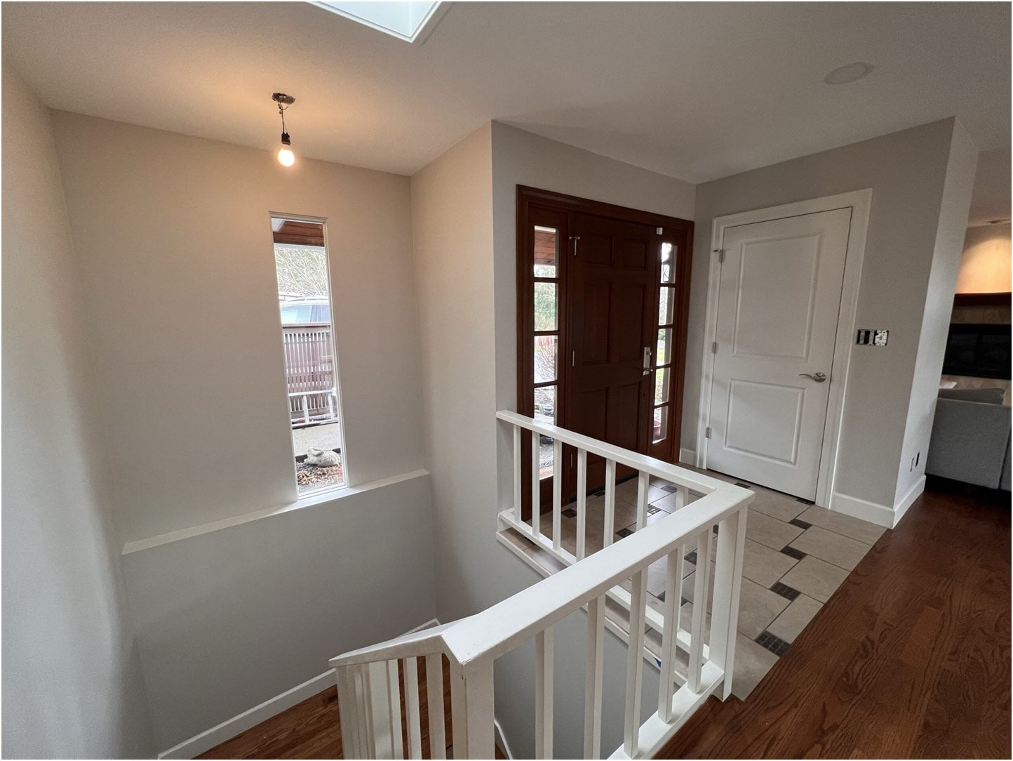 A staircase leading to a kitchen in a home, beautifully transformed by the professionals at Pearl Painters with their great paint job.