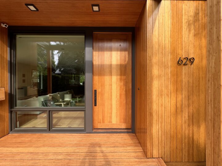 Modern wood door and a wood-paneled wall, maintained by Pearl Painters for Portland home painting.