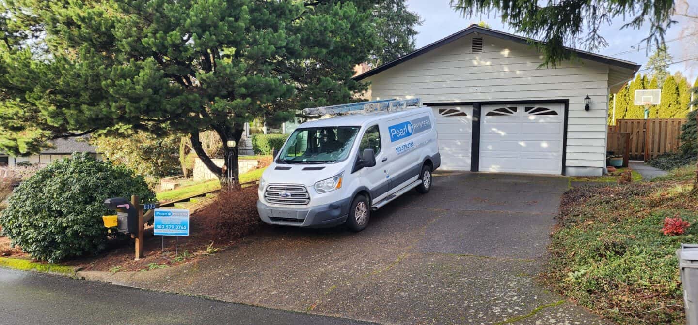 A white van parked in front of a home in Portland.