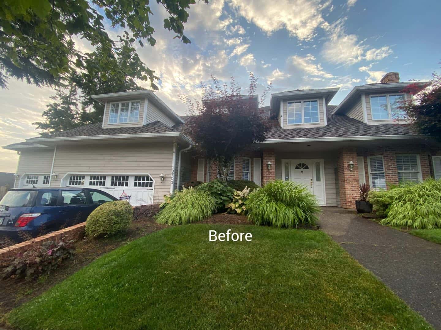 A homeowner in West Linn proudly displays their freshly painted house, with a car parked in front.