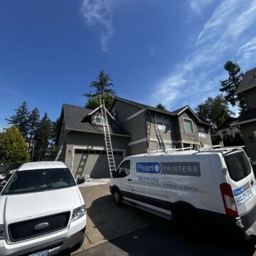 Two vehicles, including a "Pearl Painters" van, are parked in front of a house in Austin with ladders set up for exterior painting. The weather is clear and sunny in May 2025.