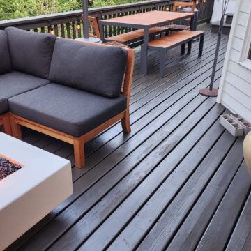 A fire pit on a refinished deck with a cozy couch in Portland, Oregon