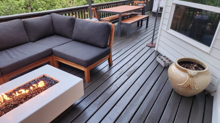 A fire pit on a refinished deck with a cozy couch in Portland, Oregon