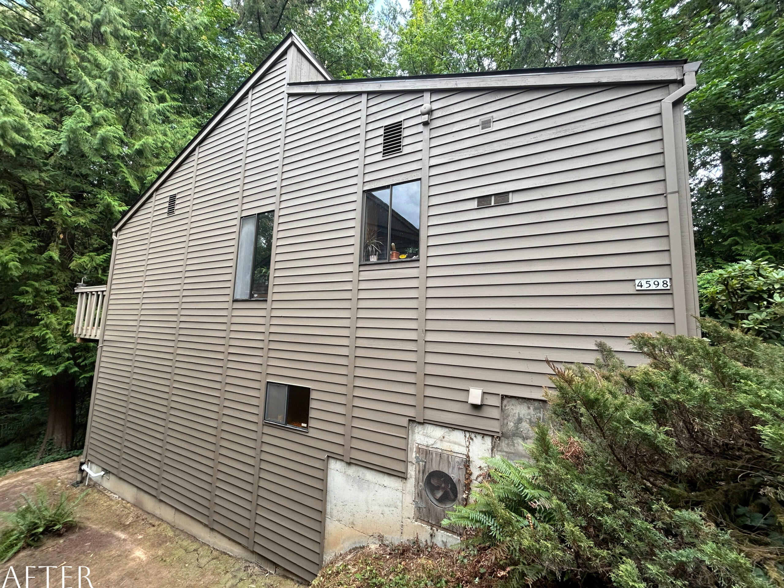 A Portland home in the woods with a brown siding, ready for an exterior paint project to give it a fresh feel.