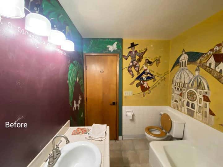 A bathroom with a colorful mural on the wall, painted by Pearl Painters.