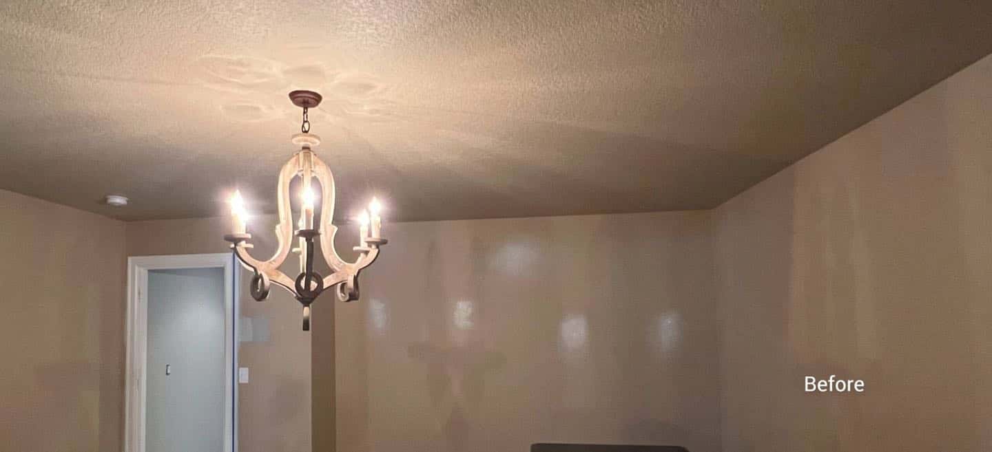 A beautiful dining room in a West Linn home with a chandelier hanging above a table.