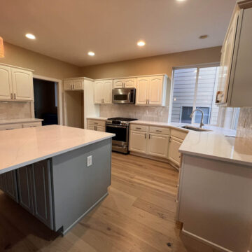 A Northwest Portland kitchen with white cabinets and hardwood floors, perfect for a cabinet update.