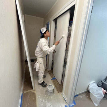 Portland painter painting a door in Deanne's home.