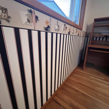 A room with a black and white striped wall.