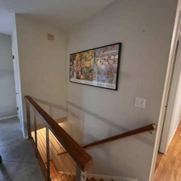 A view of the stairs leading to a dining room.