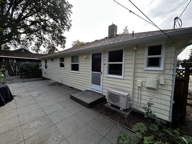 Single-story Gies house in Portland with beige siding, painted by Pearl Painters. AC unit by patio. Multiple windows visible.