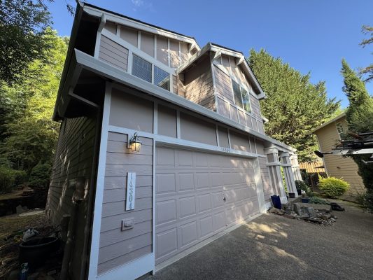 Painted by Pearl Painters in Portland, the Anderson two-story house has light purple siding, white trim, and garage at 4830.