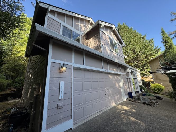 Painted by Pearl Painters in Portland, the Anderson two-story house has light purple siding, white trim, and garage at 4830.