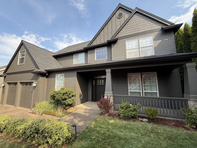 Pearl Painters painted this two-story dark gray house in Portland; features porch, 3-car garage. Available August 2025.