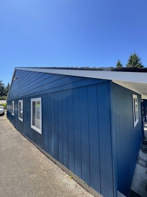 Painted blue building with white trim in Deppe, July 2025; painted by Pearl Painters, Portland painting company.
