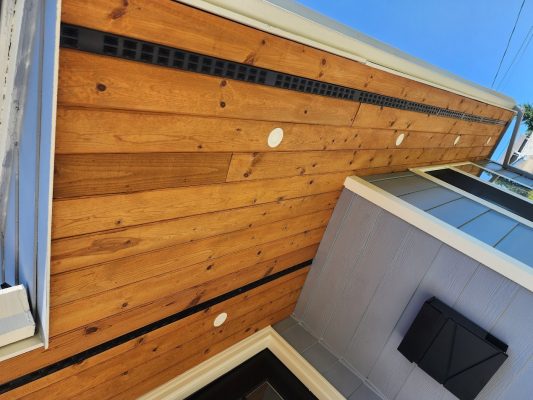 Painter’s view of Arnold house in August 2025, gray siding and wood soffit with vents, Pearl Painters, Portland.