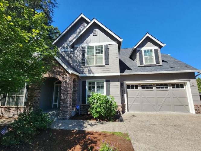 Holley two-story house in Portland with gray siding and stone accents; painted by Pearl Painters. Completion by July 2025.