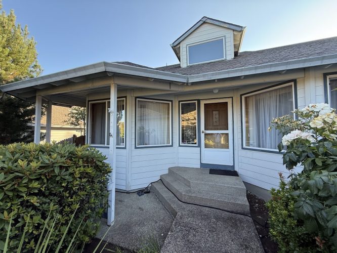 Light blue house exterior in Portland with porch and white windows, painted by Pearl Painters, July 2025 for Nomura.