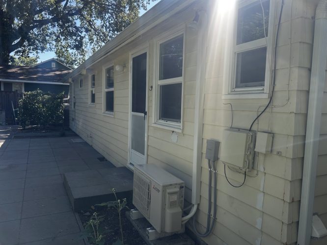 Gies house in Portland with beige exterior, windows, and patio; shown before painting by Pearl Painters in July 2025.