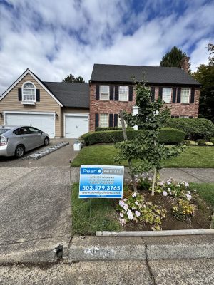 Pearl Painters sign on lawn of two-story brick and wood house in Portland; exterior painting set for August 2025.