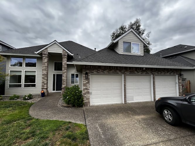 Featherstone two-story house with brick and siding, three-car garage, black car; painted by Pearl Painters in Portland.