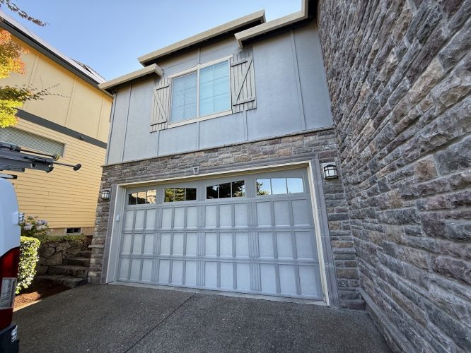 Two-story house with stone, gray siding, shuttered windows. Pearl Painters van visible. Doan listing, July 2025, Portland.