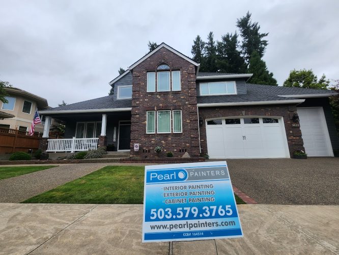 Pearl Painters sign in the yard of a two-story brick house advertises painting services, July 2025, Portland.