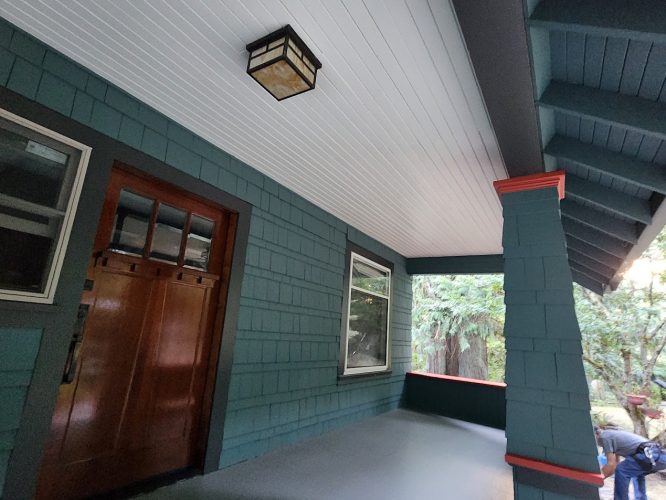 Pearl Painters painted the Gentry house porch teal in Portland; wood door, window, light, pillar, and trees are visible.