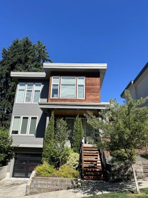 Modern two-story house with wood and grey siding, painted by Pearl Painters in Portland. Shimek project, July 2025.