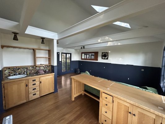 Interior room in Portland with wooden floors, desk, countertop, sink, skylights; design by Dennis for Pearl Painters or painters.
