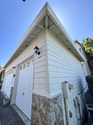 White detached garage with stone trim in Jennings; closed doors; possible painting job for Pearl Painters or Portland painter.