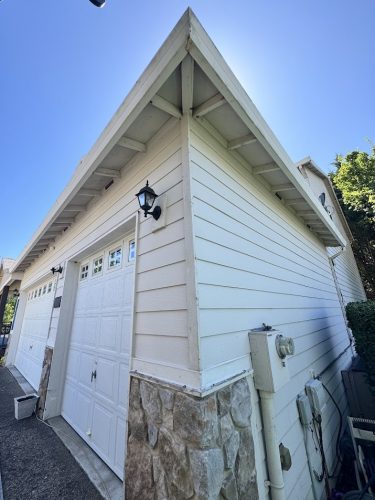 White detached garage with stone trim in Jennings; closed doors; possible painting job for Pearl Painters or Portland painter.
